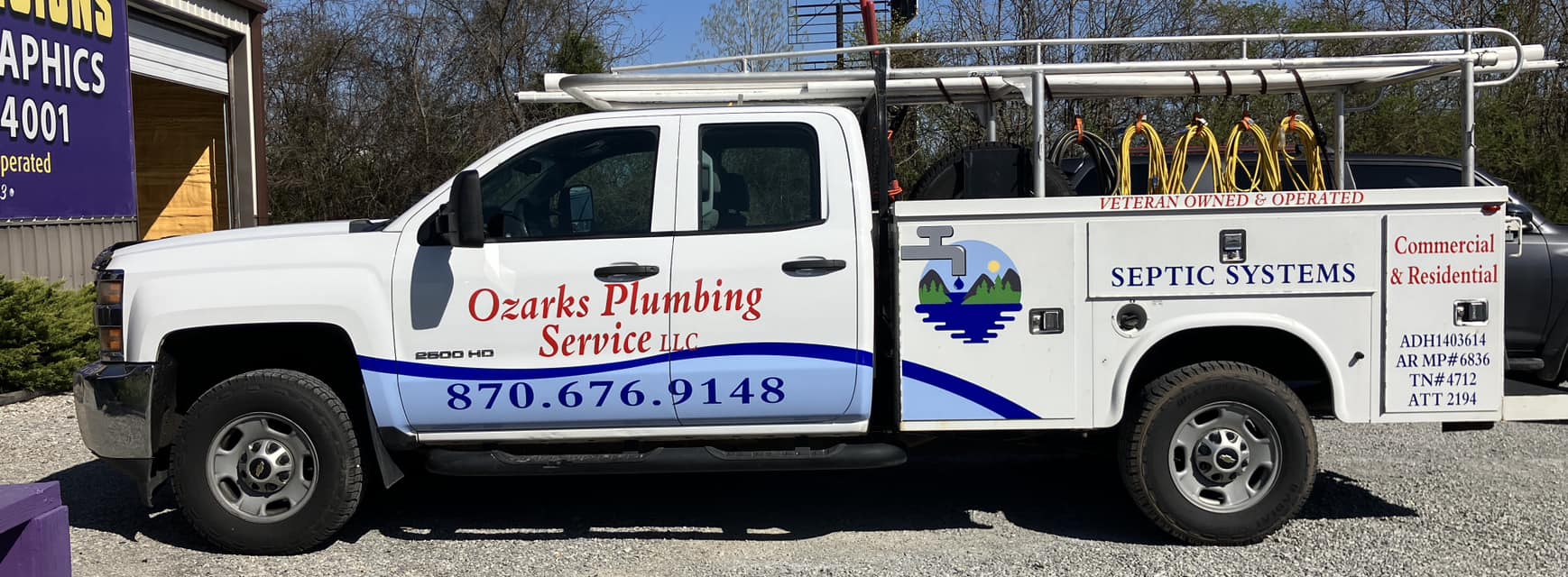 Custom vinyl graphics on white plumbing service truck for Ozarks Plumbing Service LLC