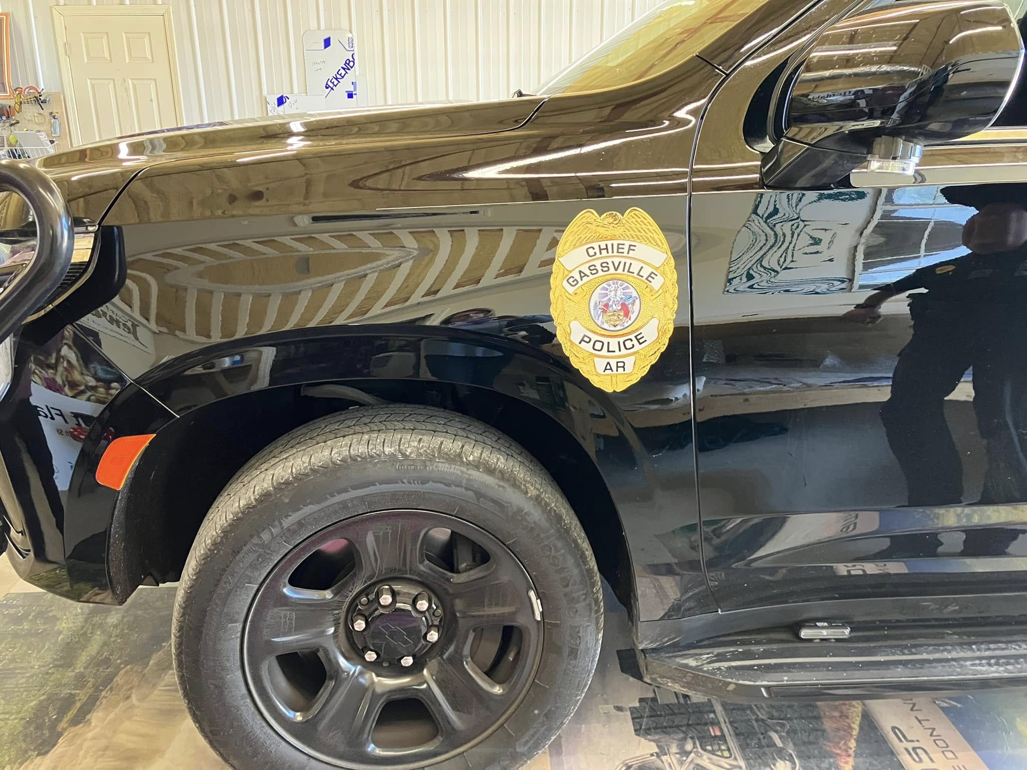 Gassville Police Chief's gold badge decal on the side of a black patrol car