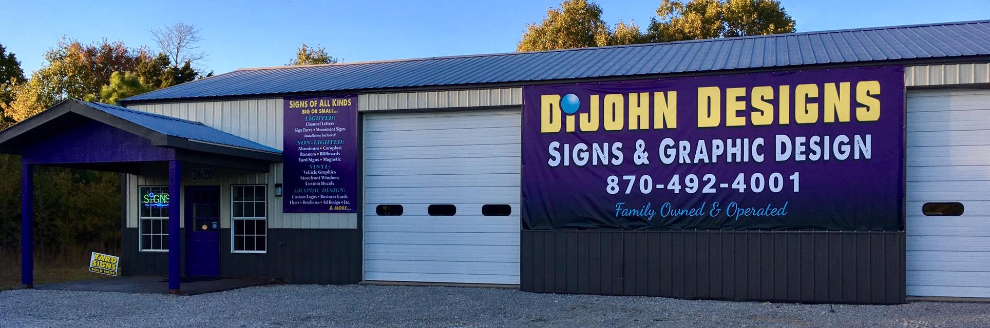 Large purple and yellow vinyl banner for DiJohn Designs, advertising signs and graphic design services.