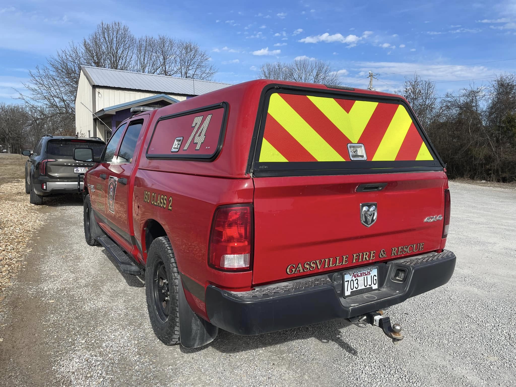 Gassville Fire & Rescue red pickup truck with reflective yellow and red chevron graphics and ISO Class 2 graphics.