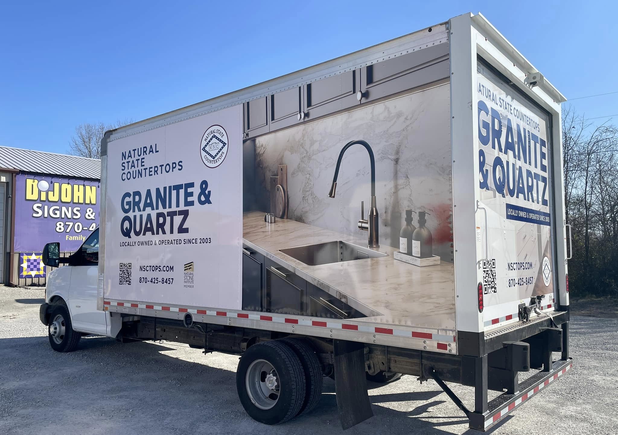 Full wrap of a white box truck for Natural State Countertops featuring kitchen design with granite and quartz.