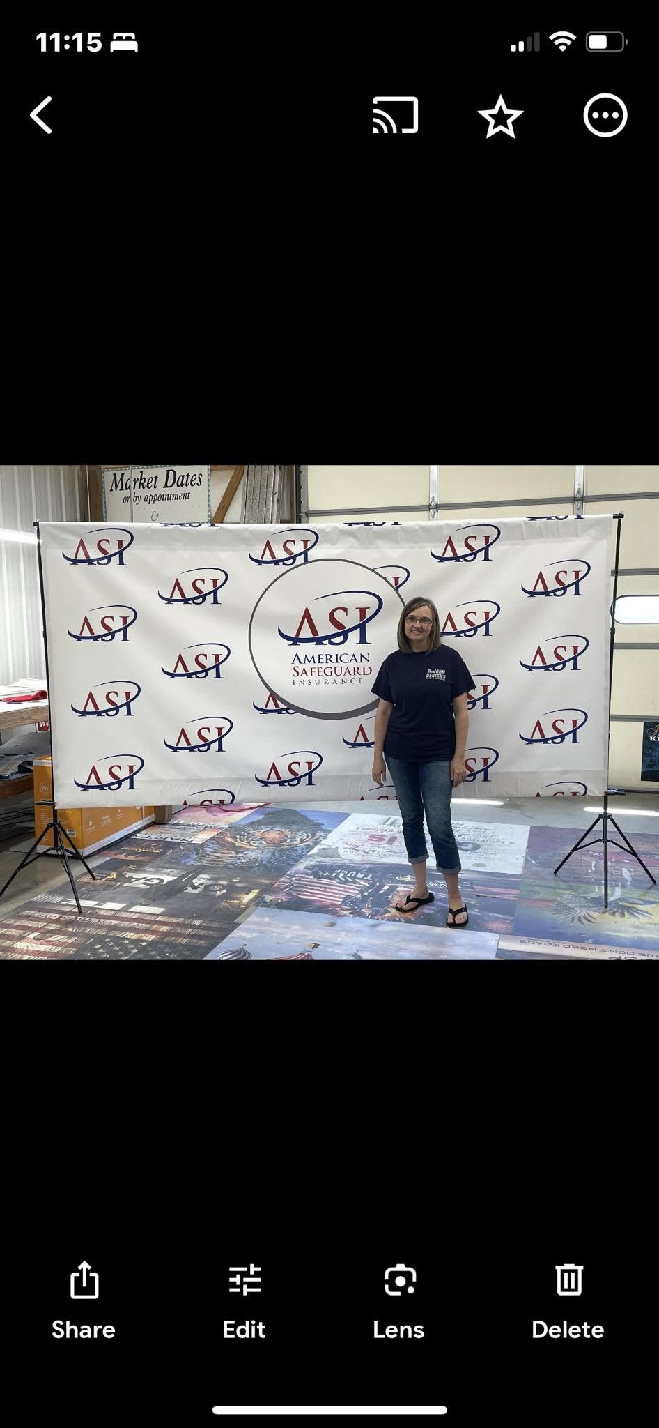 White wide-format banner with repeating ASP and large American Safeguard Insurance logo, with a woman standing in front.
