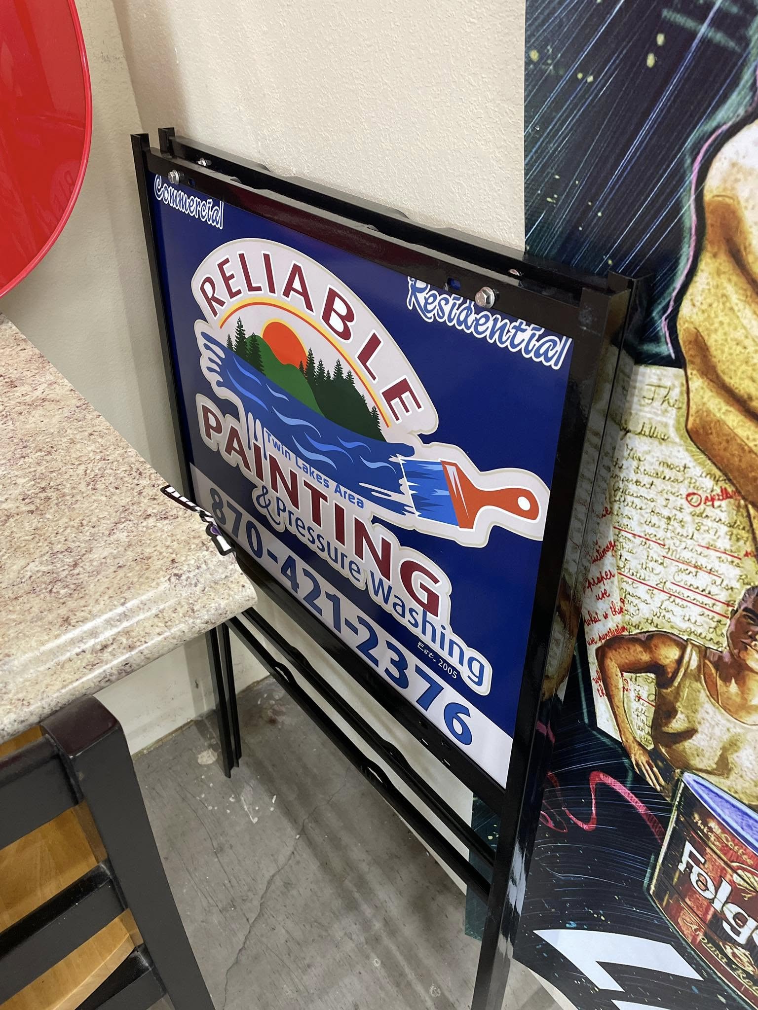 Blue and white A-frame sign for Reliable Painting & Pressure Washing, Twin Lakes Area.