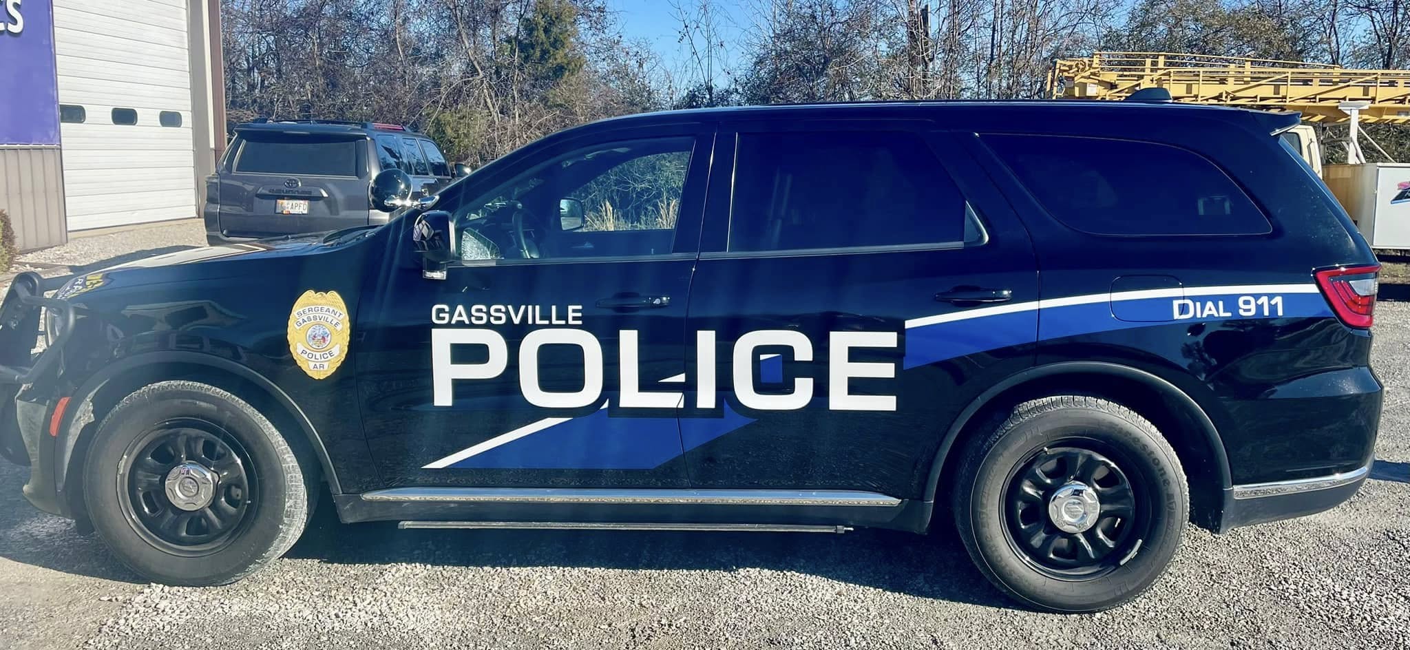 Gassville Police SUV with custom vinyl graphics, blue and white text, on a black vehicle.
