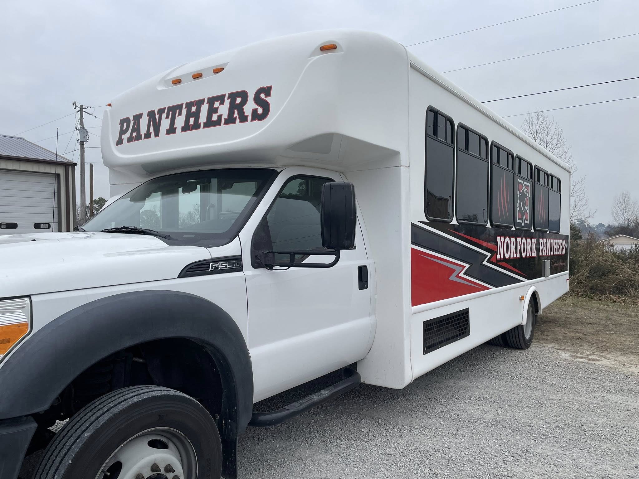 Custom vinyl graphics on white school bus for Norfork Panthers