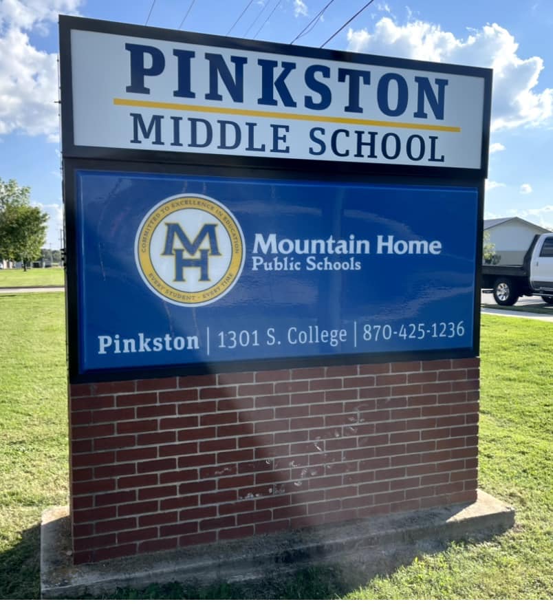 A custom brown brick monument sign with backlit white text for Pinkston Middle School