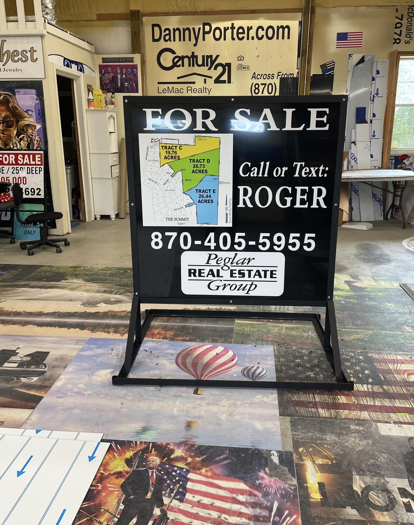 Black and white a-frame real estate sign for Peglar Real Estate Group, advertising land for sale.