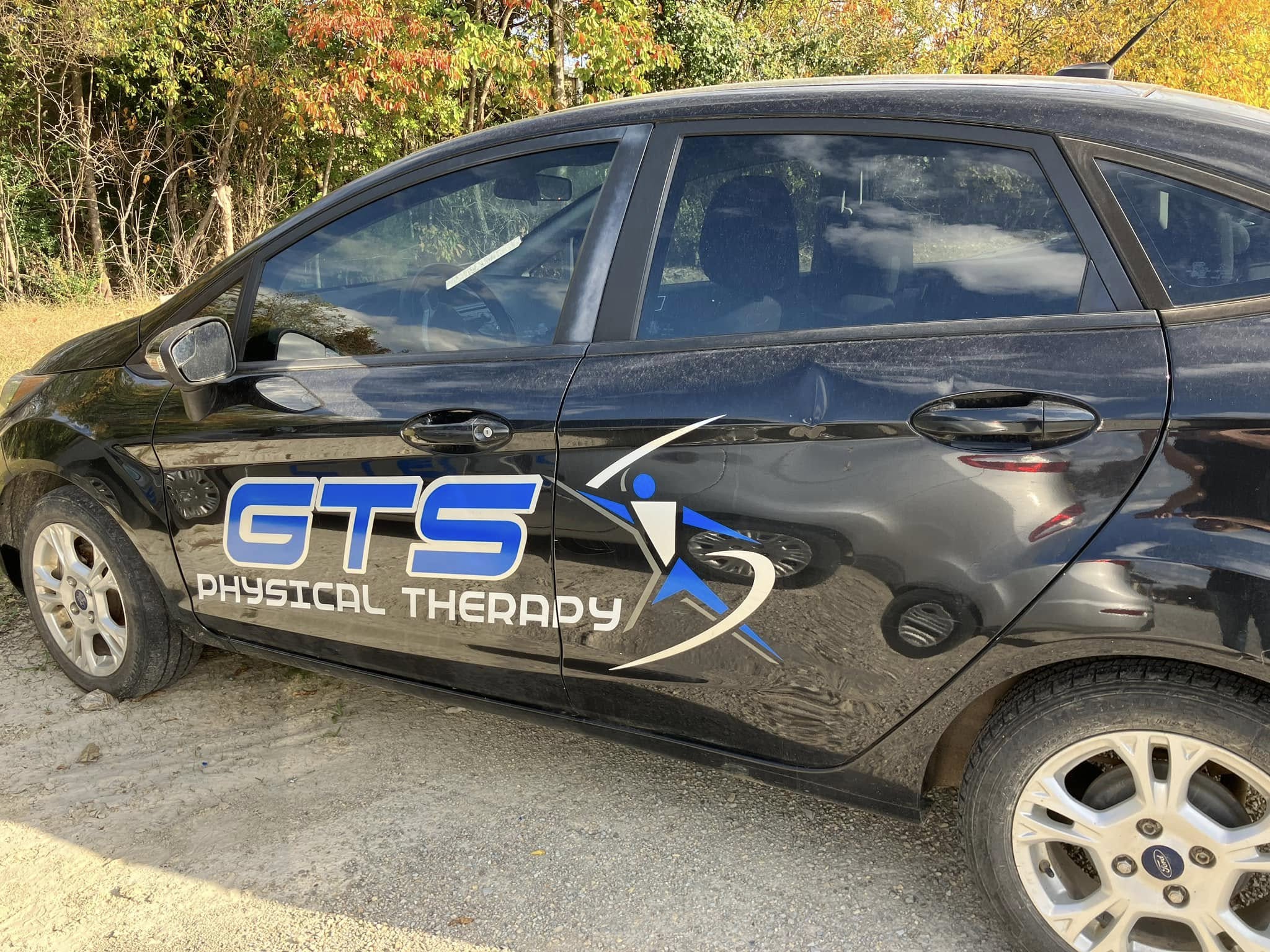 Custom vinyl graphics for GTS Physical Therapy on a black car door