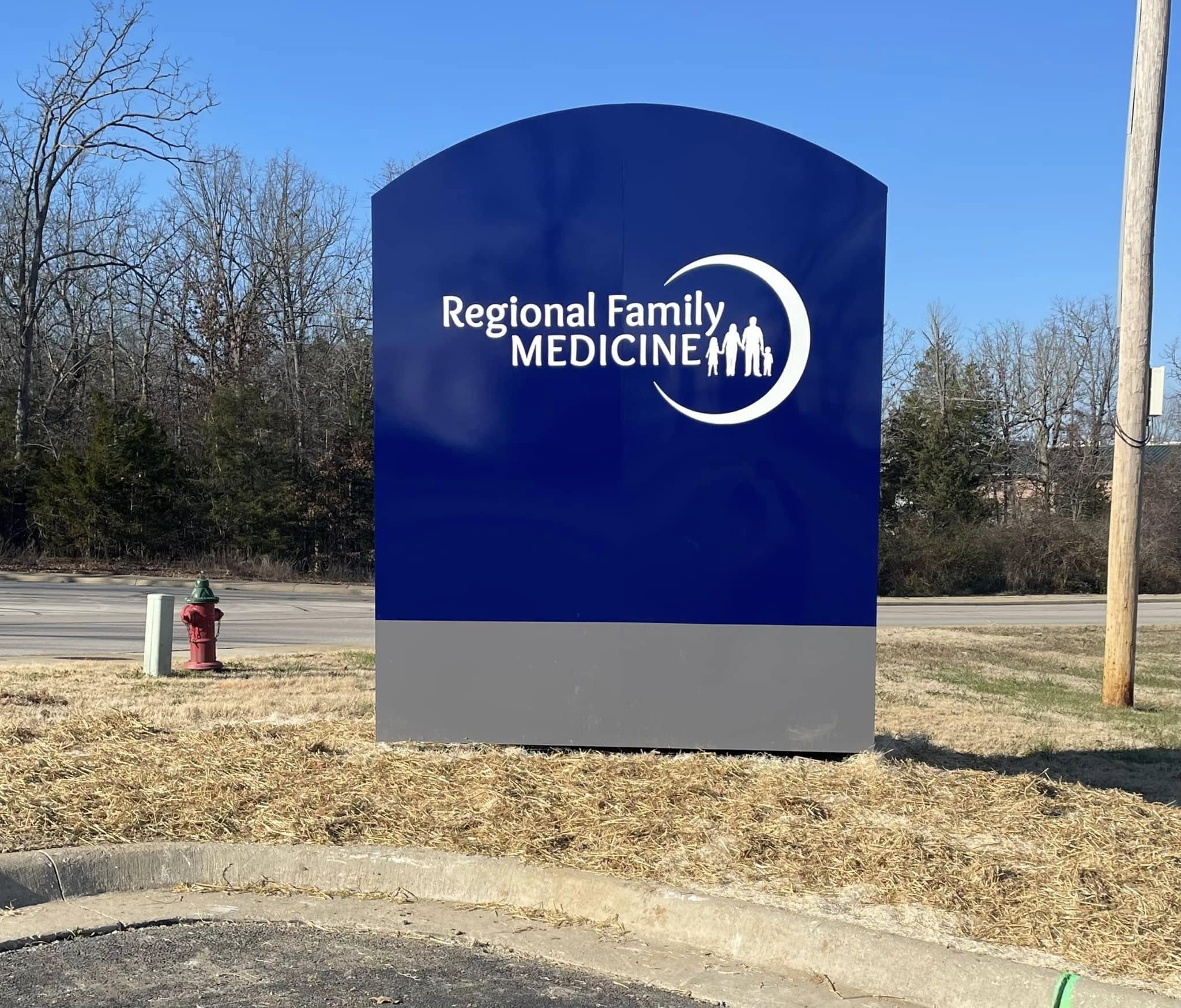 Large blue monument sign with white text 'Regional Family Medicine' and family logo.