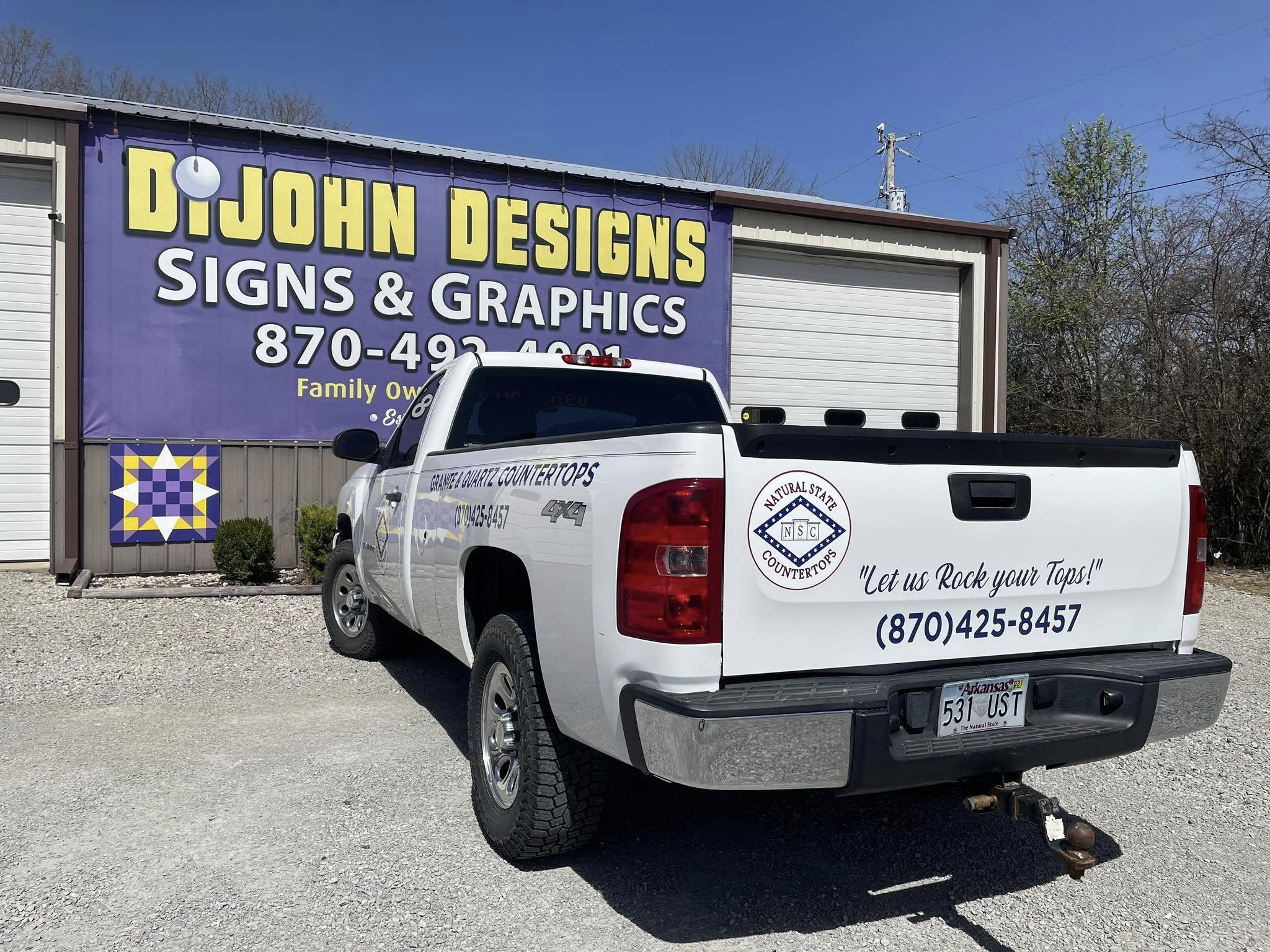 White pickup truck with a full-color vinyl decal for Natural State Countertops