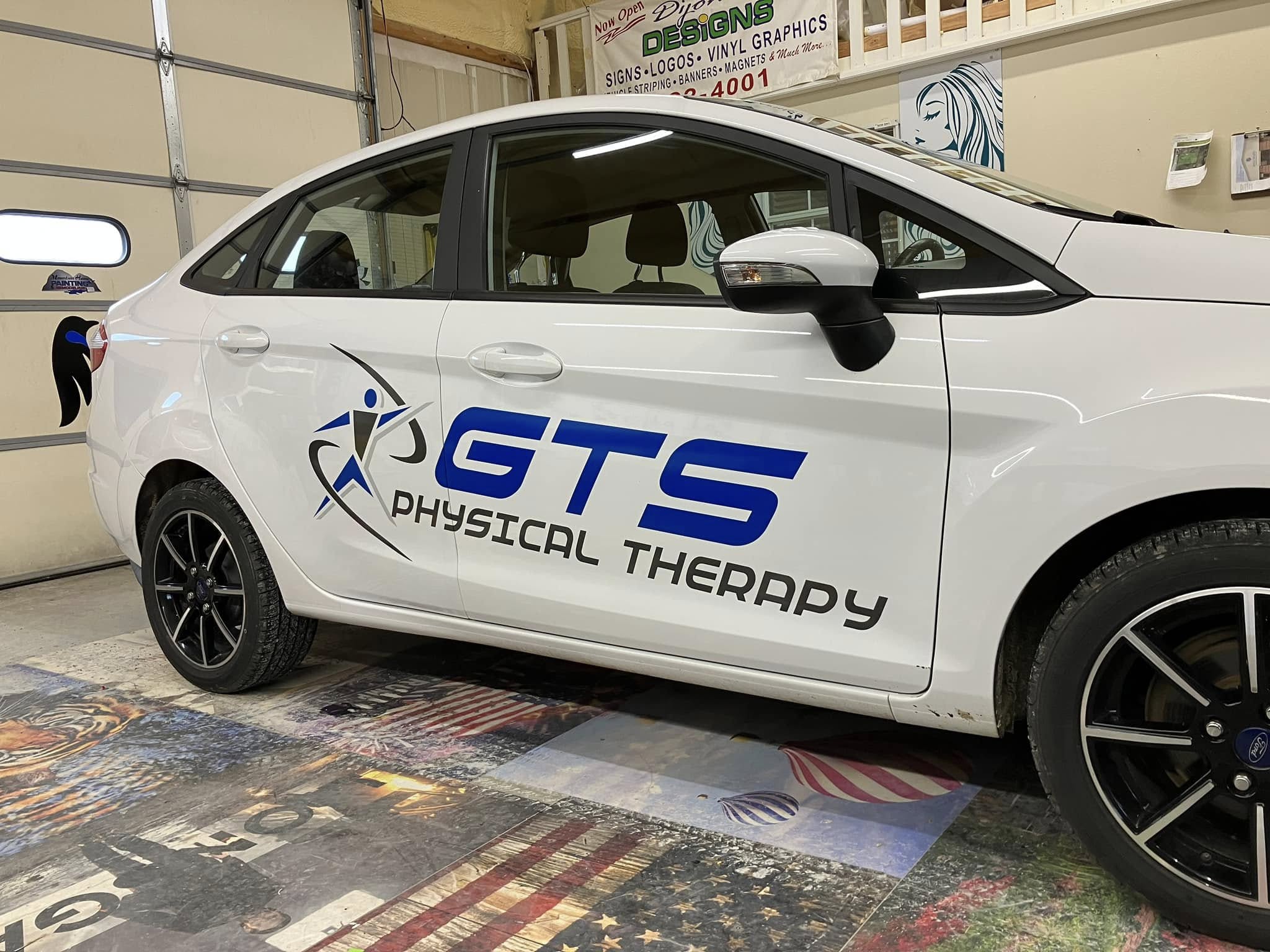 White Ford Fiesta with GTS Physical Therapy logo and lettering on the side, partial vehicle wrap.