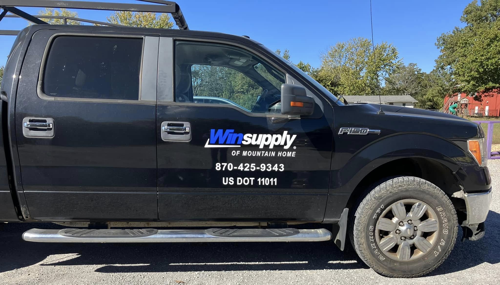 Custom vinyl graphics for Winsupply of Mountain Home on a black Ford F-150 truck