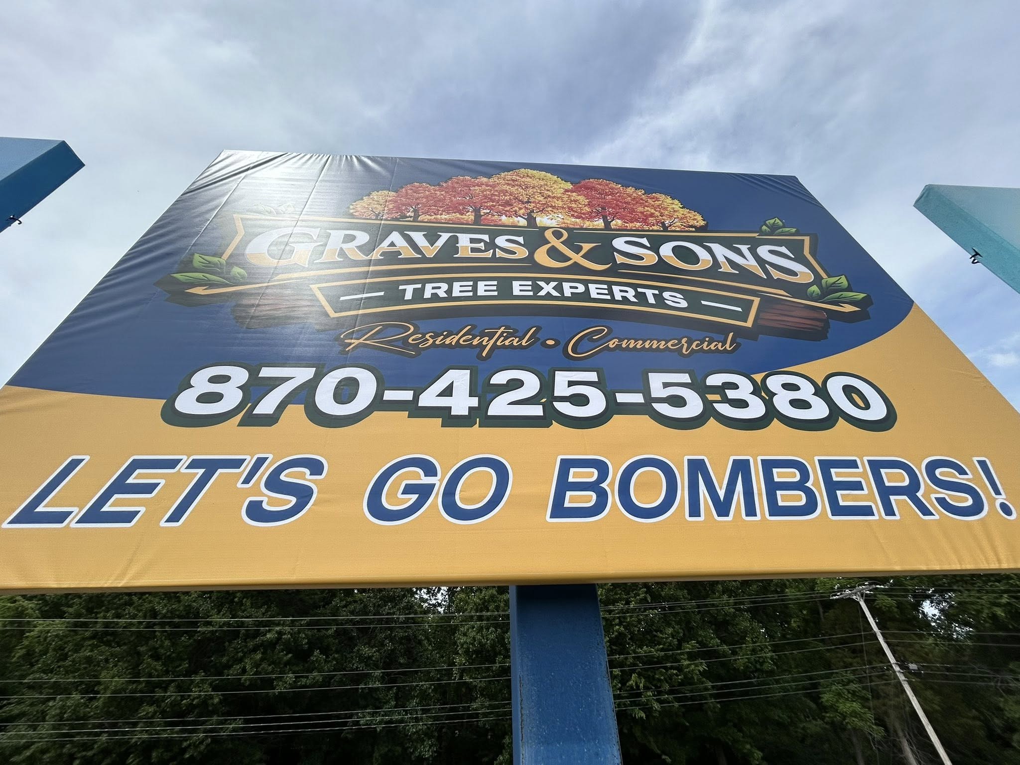 Large vinyl banner for Graves & Sons Tree Experts with bold text and tree graphics.