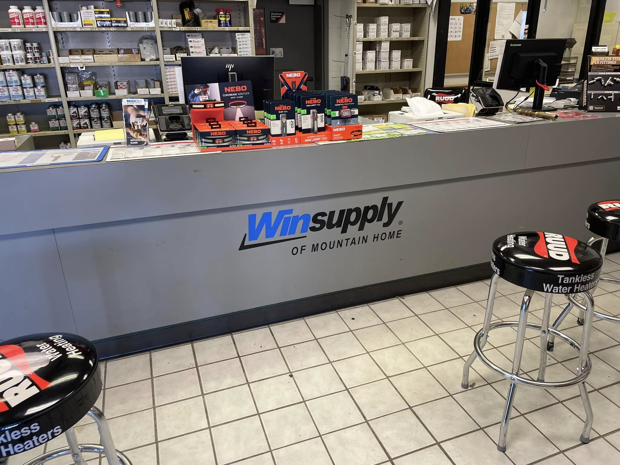 Blue and black Winsupply logo and text on gray counter-front vinyl graphic.