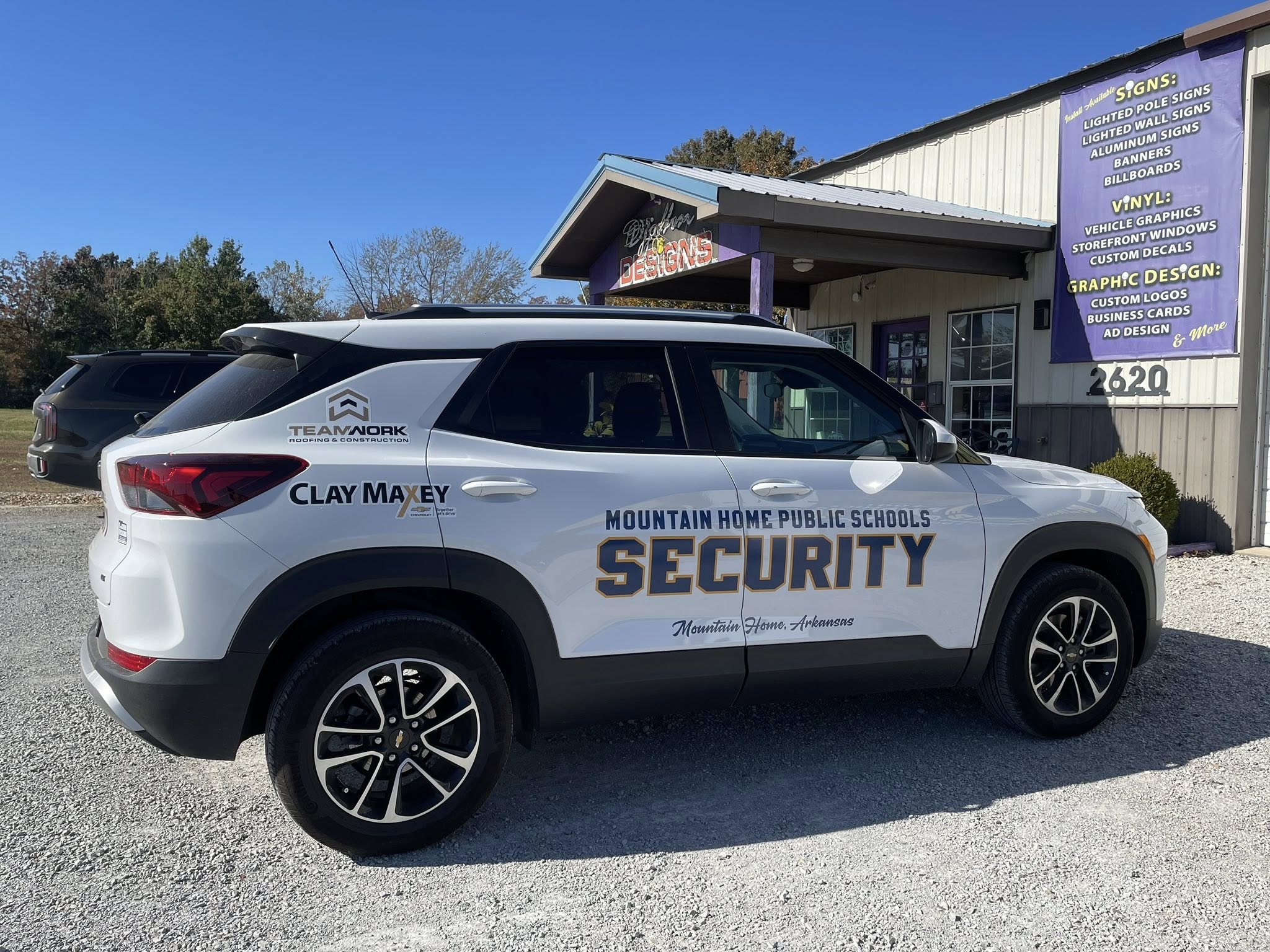 Custom vinyl graphics on white SUV for Mountain Home Public Schools security and local businesses