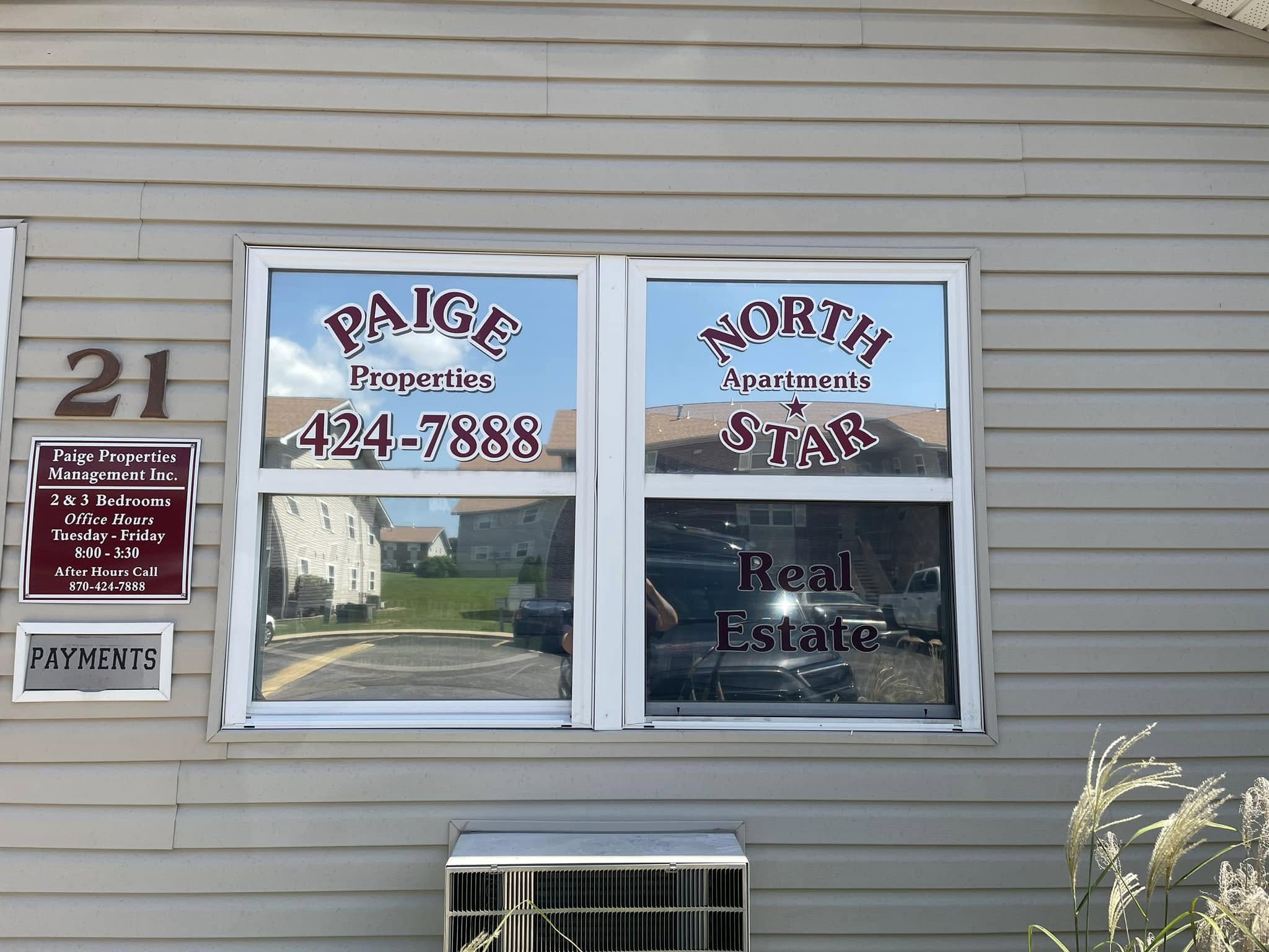 Custom vinyl window lettering and graphics for Paige Properties and North Star Apartments on a property office window.