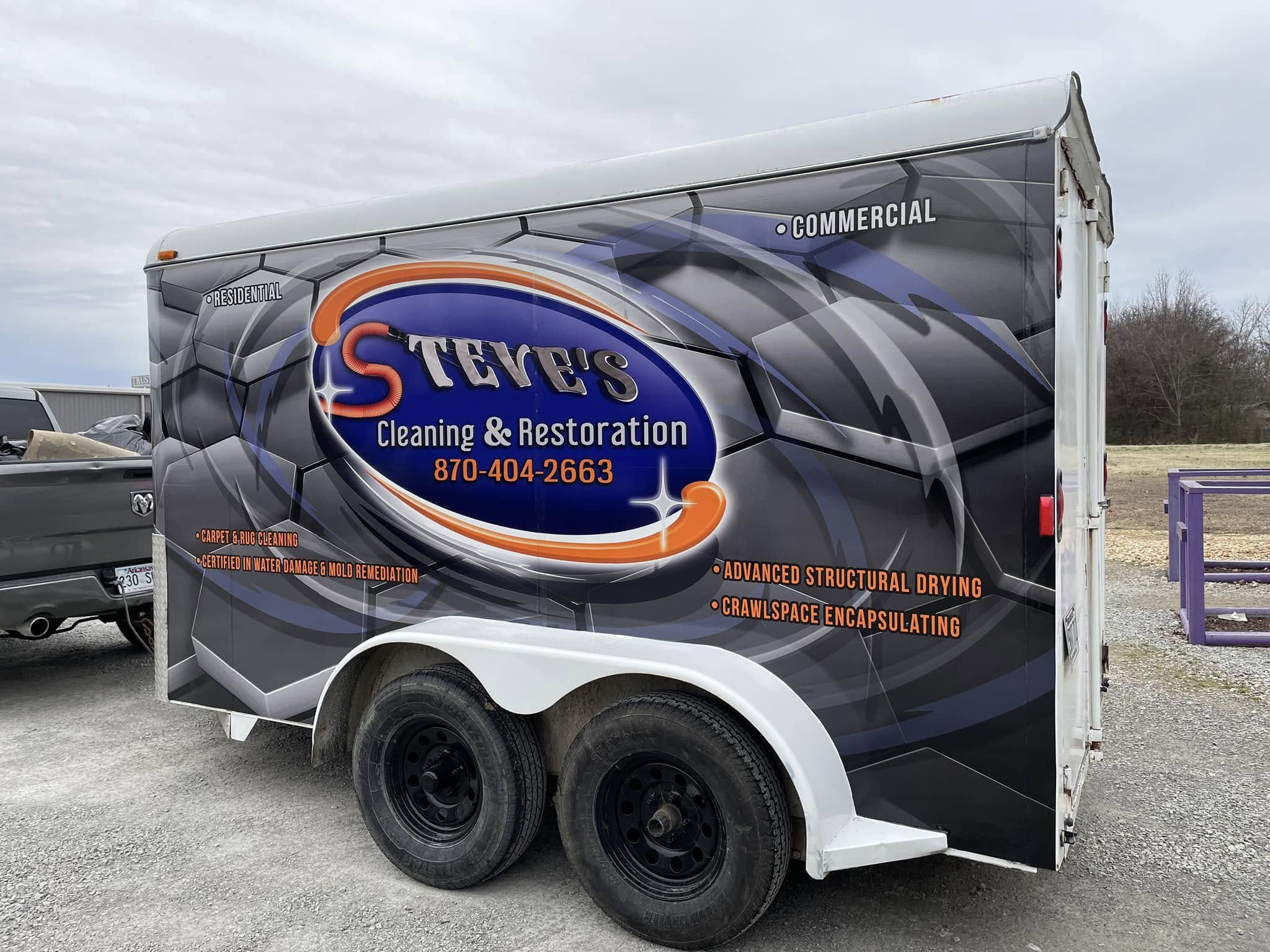 Full-color custom vinyl wrap on a white enclosed utility trailer for Steve's Cleaning & Restoration