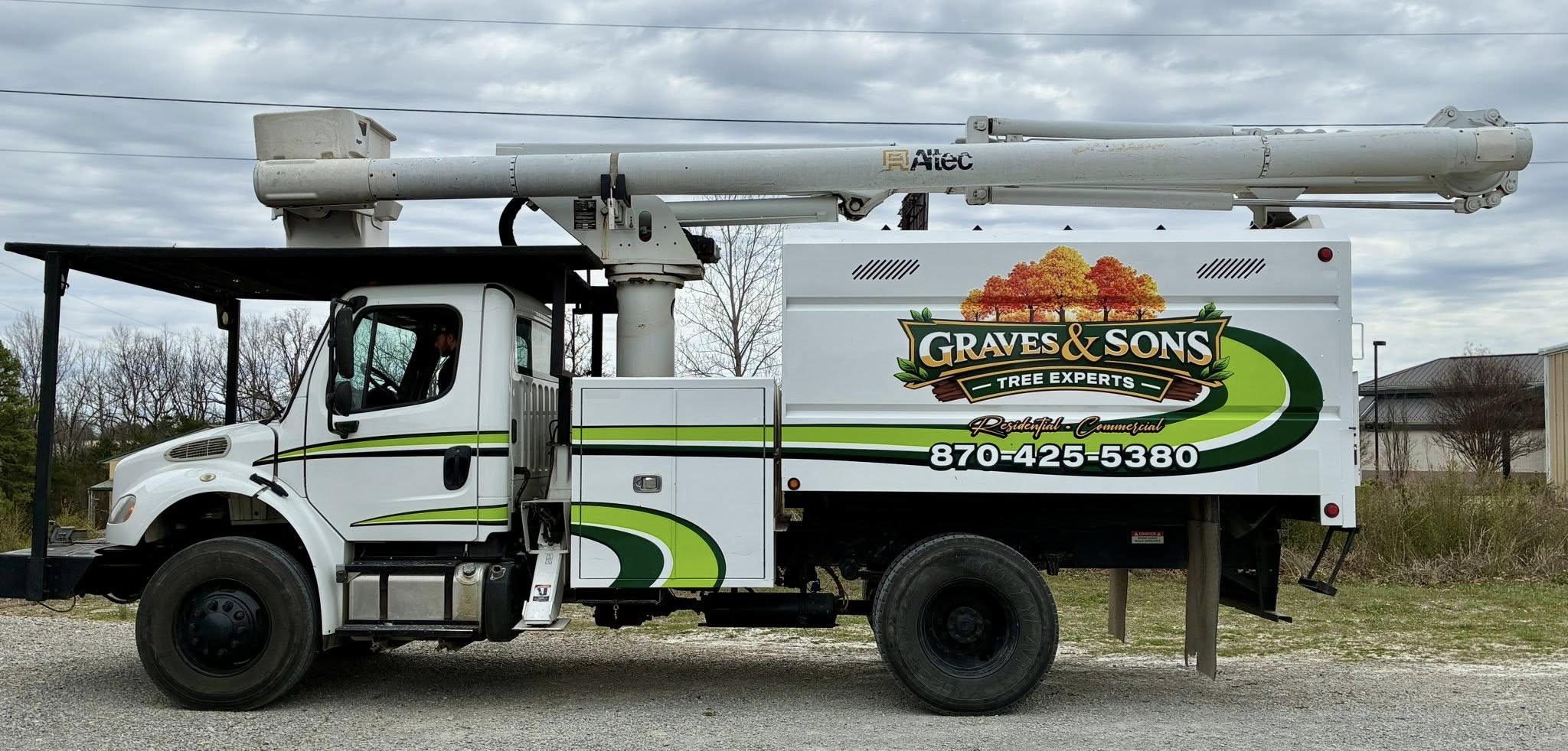Custom full-color vinyl graphics on a white commercial bucket truck for Graves & Sons Tree Experts