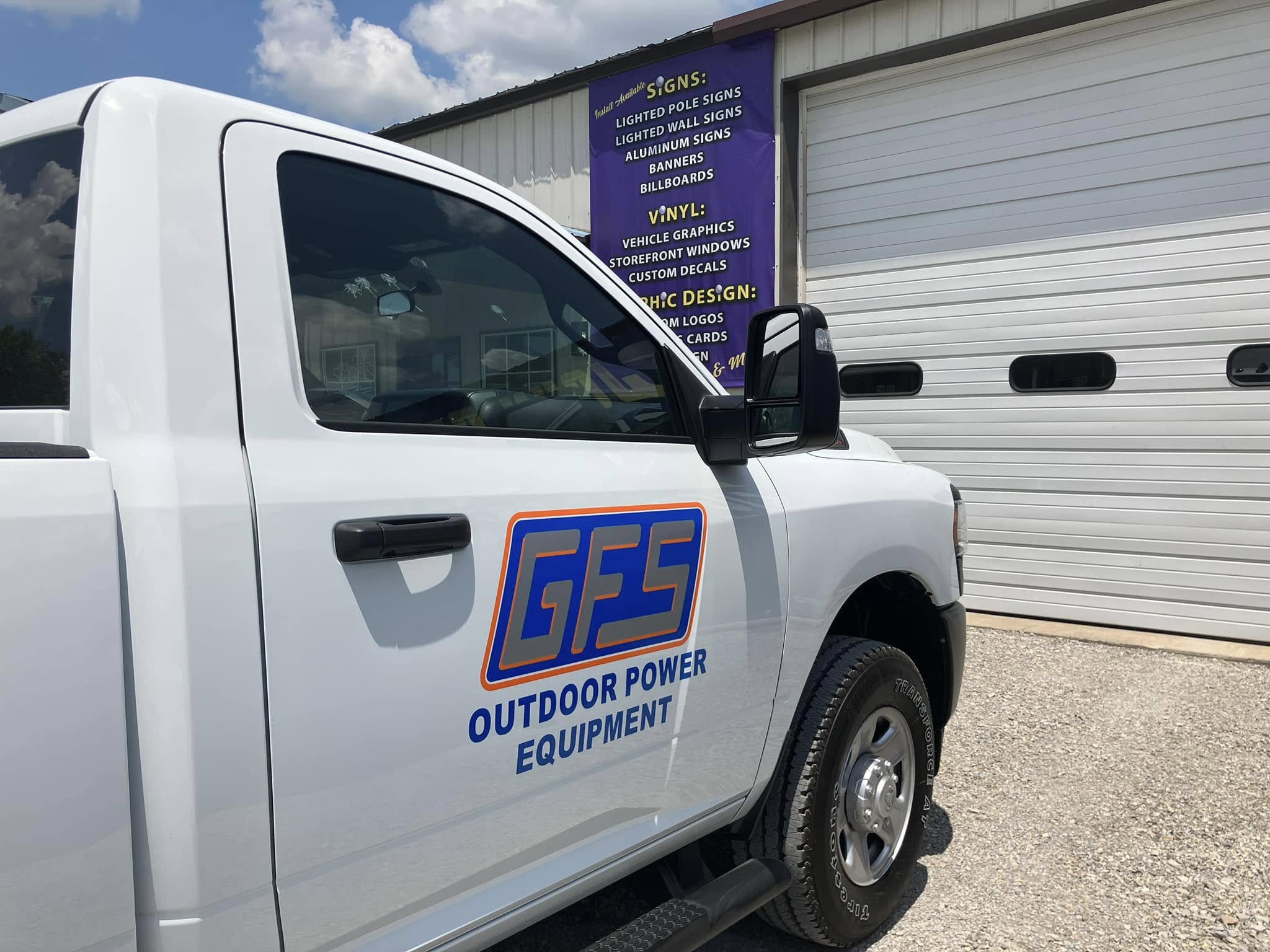 White pickup truck with orange and blue vinyl graphics for GFS Outdoor Power Equipment