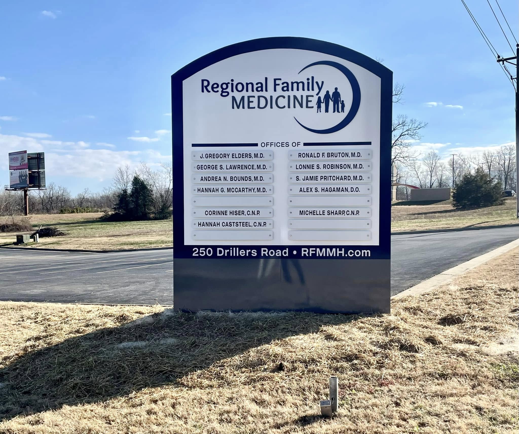 Custom monument sign for Regional Family Medicine listing doctors against blue sky backdrop.
