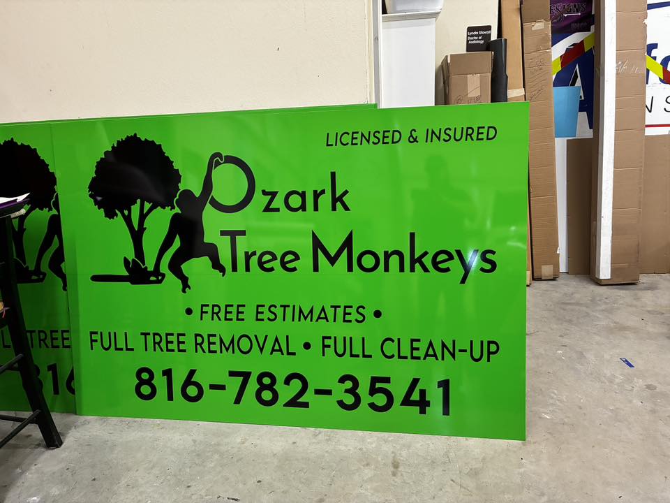 Vibrant green yard sign for Ozark Tree Monkeys with black text and ape logo.
