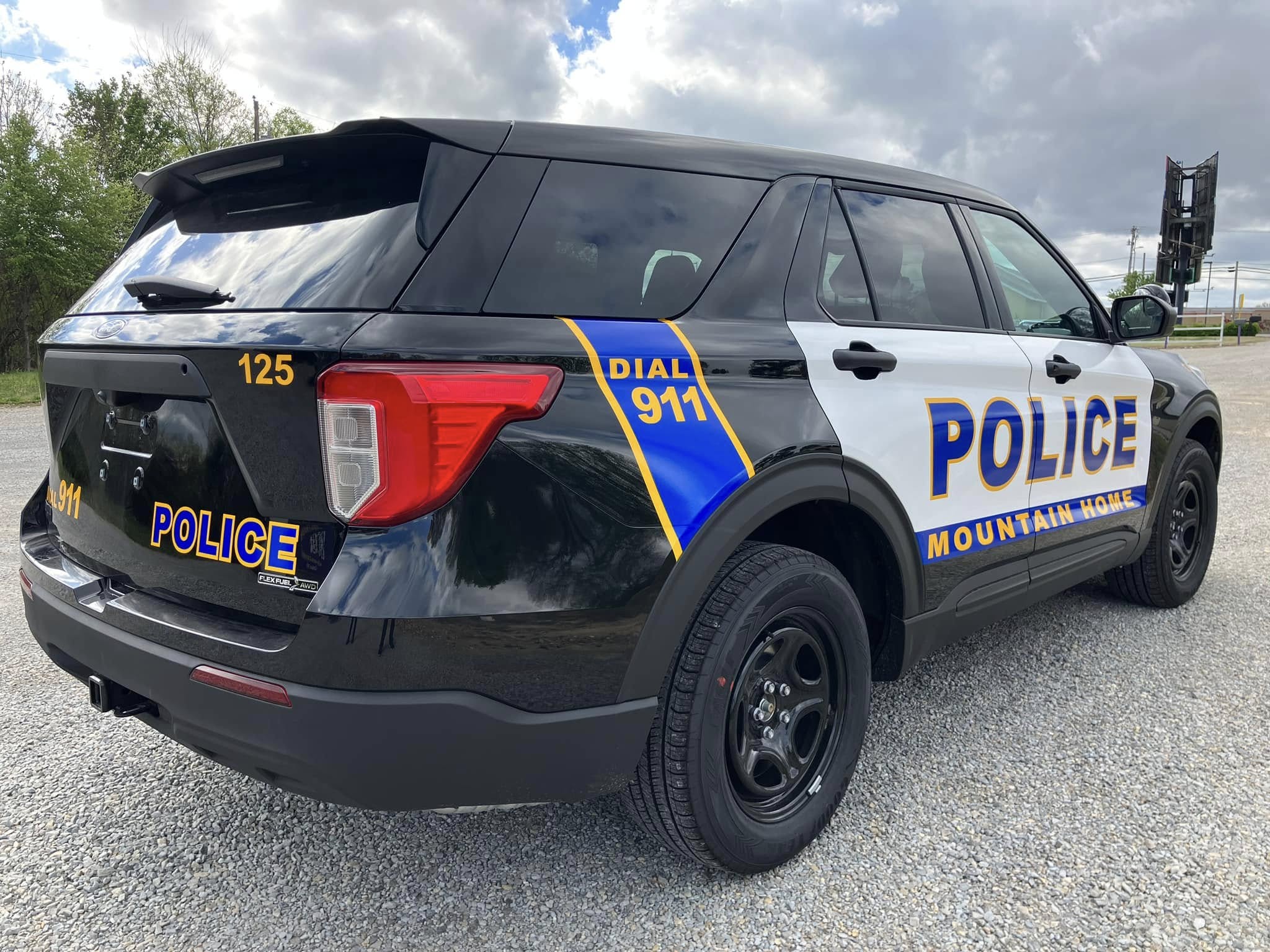 Custom police vehicle graphics on a black SUV for Mountain Home, featuring bold blue and gold accents.