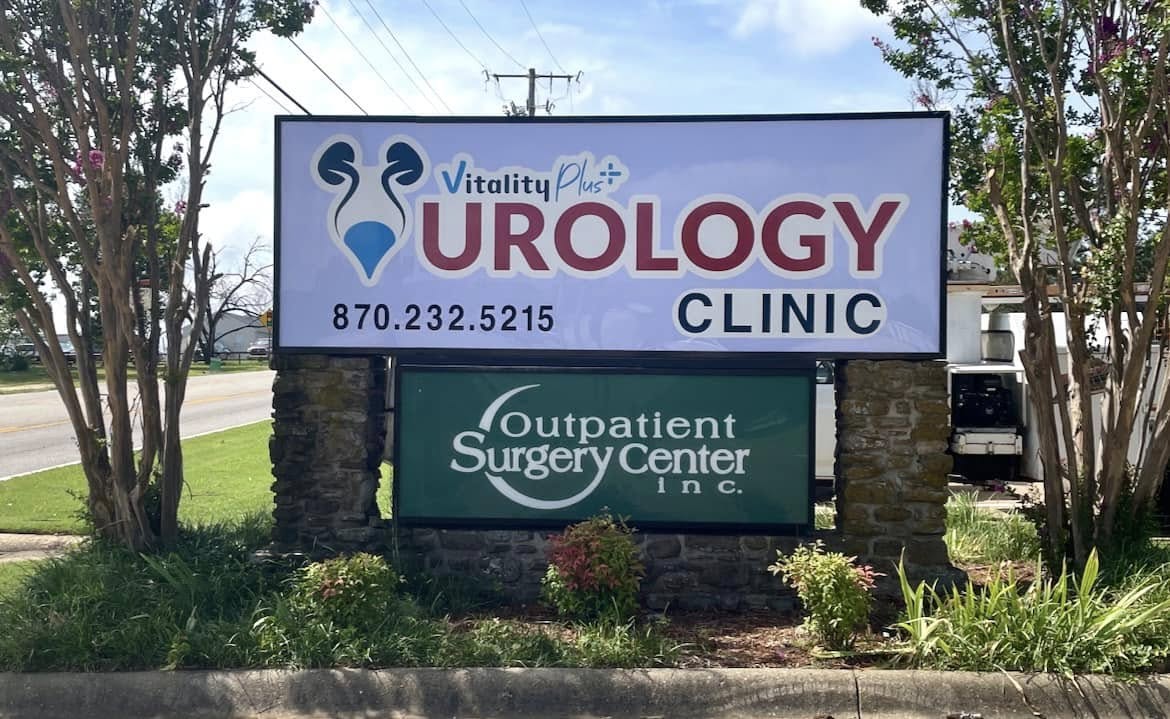 Outdoor monument sign with "Vitality Plus Urology Clinic" on top and "Outpatient Surgery Center" below.